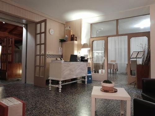 a living room with a desk and a table at Hotel Regina Yeti Bistrot in Sestola