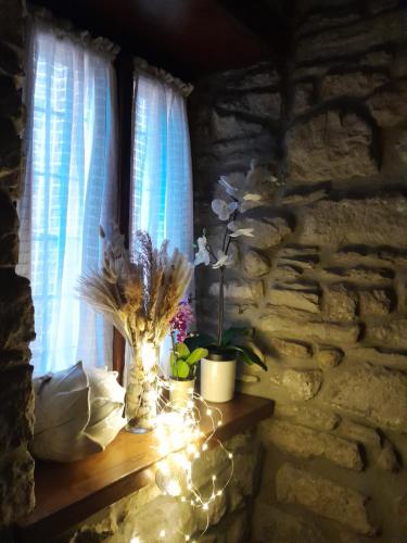 a room with a window with a vase with flowers and lights at Hotel Regina Yeti Bistrot in Sestola