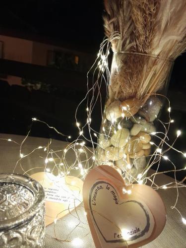 a vase filled with christmas lights and a heart ornament at Hotel Regina Yeti Bistrot in Sestola