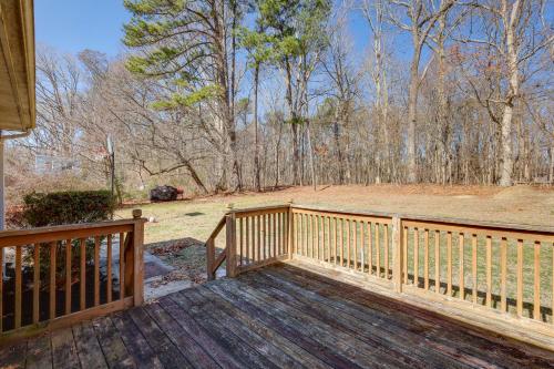 a wooden deck with a wooden railing and trees at Tranquil Delmar Home about 7 Mi to Salisbury! in Delmar