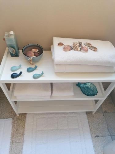 a white table with seashells and a bowl on it at Casa Argentieri 3 in Trapani