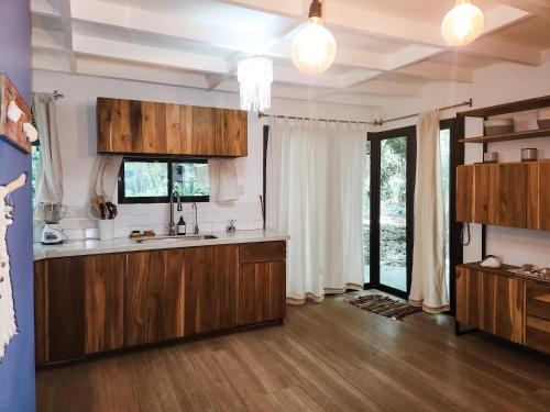 a kitchen with wooden cabinets and a sink in a room at Calala Lodge in Cabuya