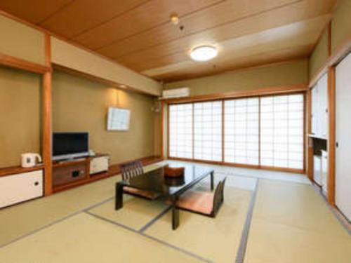a living room with a coffee table and a tv at Hotel Tetra Resort Shizuoka Yaizu - Vacation STAY 35243v in Yaizu