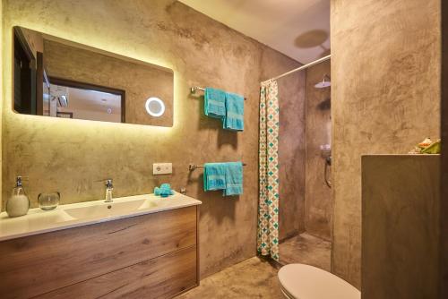 a bathroom with a sink and a shower at Villa Carina Apartments in Kralendijk