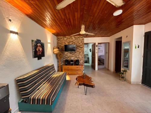 a living room with a couch and a stone wall at Jamadis in Tolú