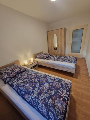 a bedroom with two beds and a mirror at Schatzberg in Überlingen