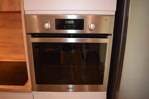 a stainless steel oven with a microwave in a kitchen at Chronos Villa Golem, Durrës in Durrës