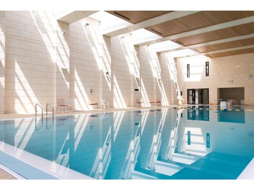 une piscine à l'eau bleue dans un immeuble dans l'établissement Nanki Shirahama Resort Hotel - Vacation STAY 38055v, à Asso
