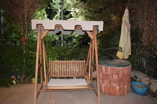 a gazebo with a bench and a barrel at Chronos Villa Golem, Durrës in Durrës