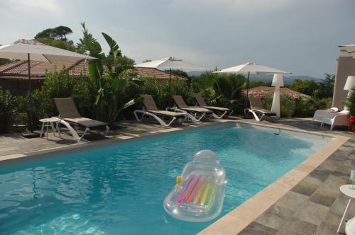 a pool with a inflatable raft in the water at chambre villa 4 in Servas
