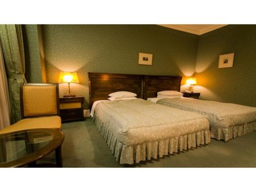 two beds in a hotel room with two lamps at Nanki Shirahama Resort Hotel - Vacation STAY 38054v in Asso