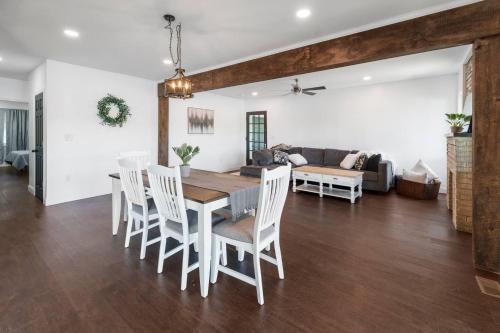 a dining room and living room with a table and chairs at RiverSuite1 - A mesmerizing river and bridge view. in Russell