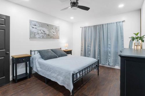 a bedroom with a bed and a ceiling fan at RiverSuite1 - A mesmerizing river and bridge view. in Russell
