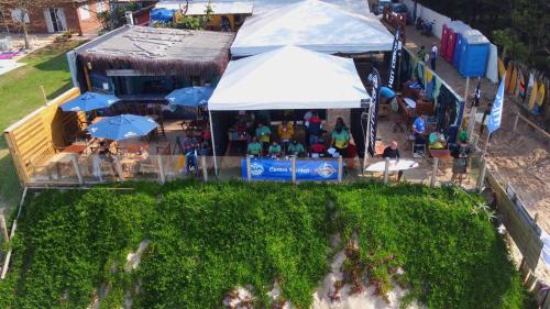 an overhead view of a farmers market with tables and umbrellas at Graffi Beach House in Florianópolis