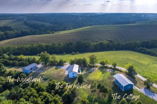 an aerial view of a house on a green field at 100 Acre Relaxing Retreat Near Ark- The Farmhouse in Williamstown