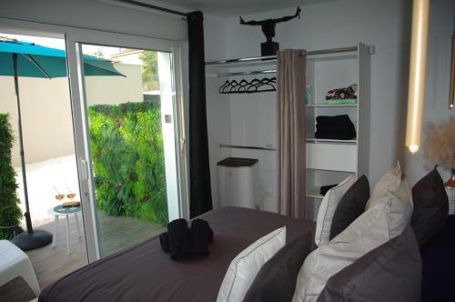 a living room with a couch and a sliding glass door at chambre villa 4 in Servas