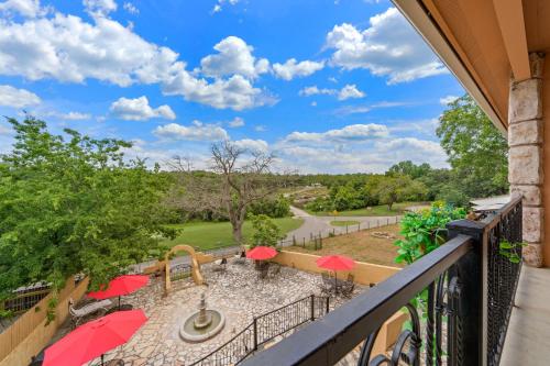 a balcony with red umbrellas and a playground at Blanco Riverside Cottages in Blanco