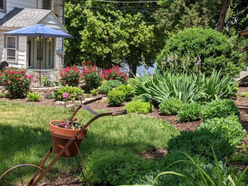 a garden with a wheelbarrow in the grass at Casual Living Extended Stay Hotels in Algonquin