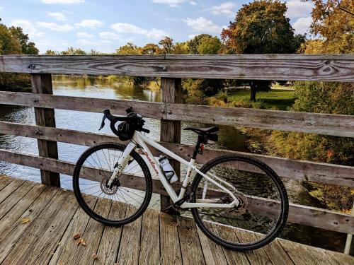 a bike is parked on a wooden bridge at Casual Living Extended Stay Hotels in Algonquin