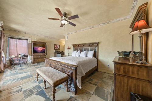 a bedroom with a bed and a ceiling fan at Blanco Riverside Cottages in Blanco