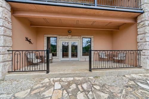 a front porch of a home with wrought iron gates at Blanco Riverside Cottages in Blanco