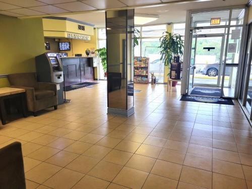 a lobby of a store with a waiting area with a lobby at Days Inn by Wyndham Alexandria South in Alexandria