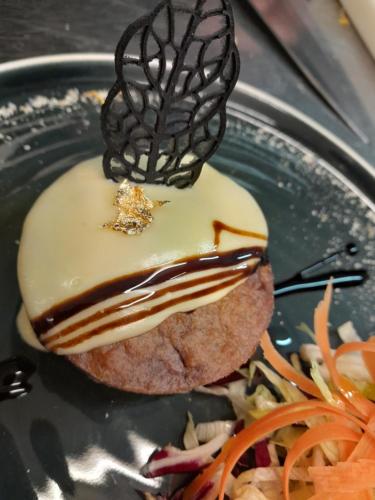 a plate with a dessert with chocolate on it at Hotel Regina Yeti Bistrot in Sestola