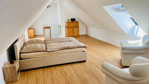 a bedroom with two beds and a staircase at Ferienwohnung Burgblick in Waldkirch