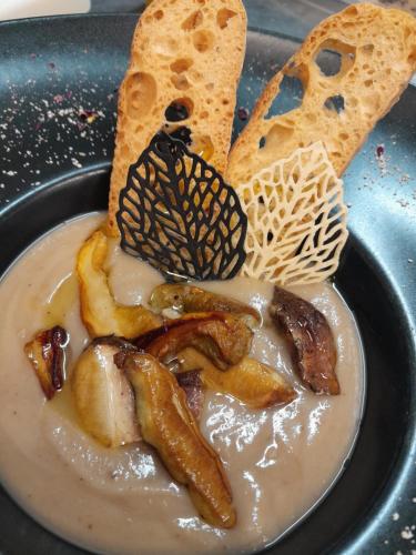 a plate of food with a bowl of dip and bread at Hotel Regina Yeti Bistrot in Sestola
