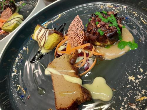 a plate of food with food on a table at Hotel Regina Yeti Bistrot in Sestola