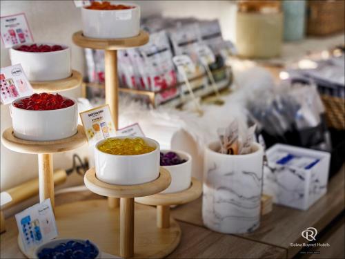 a display of bowls of food on a shelf in a store at Daiwa Roynet Hotel Nishi-Shinjuku PREMIER in Tokyo