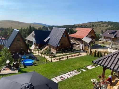 an aerial view of a village with houses and an umbrella at Vila Deniri in Zlatibor