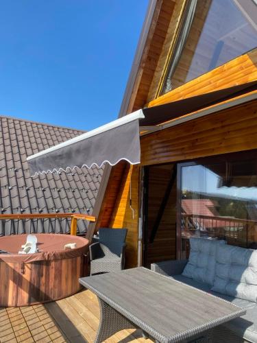 a patio with a table and a patio umbrella at Vila Deniri in Zlatibor