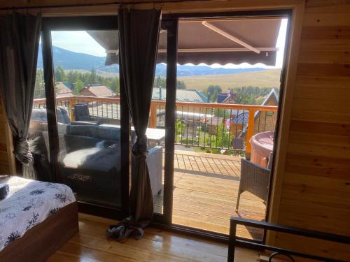 a room with a view of a balcony with a bed at Vila Deniri in Zlatibor
