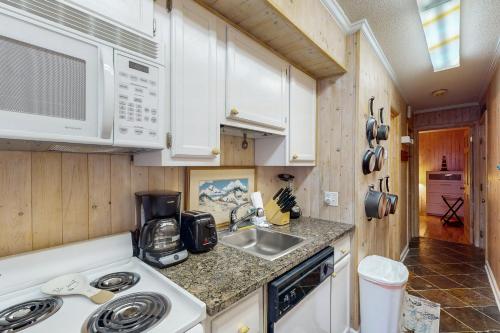 a kitchen with a sink and a microwave at A Place At The Beach 122 in Atlantic Beach