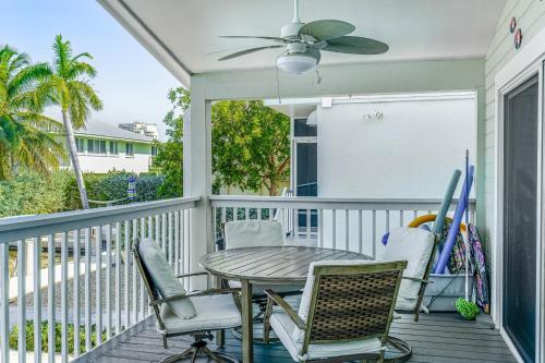 a porch with a table and chairs and a ceiling fan at Ocean Oasis II in Key Colony Beach
