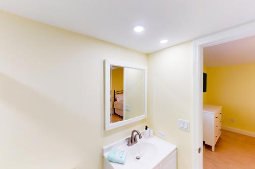 a bathroom with a sink and a mirror at Palm Breeze Retreat 320 & 330 in Key Colony Beach