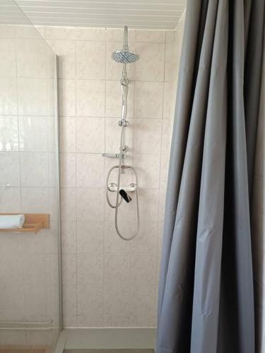 a shower in a bathroom with a shower curtain at T1 bis à proximité de la plage in Le Gosier