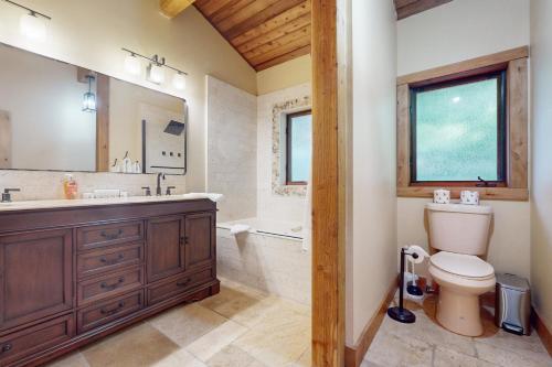 a bathroom with a sink and a toilet and a tub at Wild Horse Hideaway in Incline Village