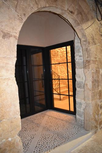 an entrance to a building with a door with a window at La Casa del Campanar in Traiguera