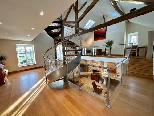 a room with a spiral staircase in a house at Le domaine de Brie in Châtillon-la-Borde