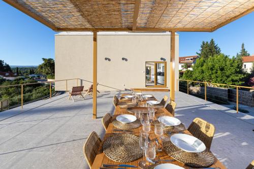 a group of tables and chairs on a patio at Nine Olives Hvar in Stari Grad