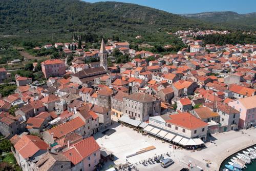 an aerial view of a town with red roofs at Nine Olives Hvar in Stari Grad