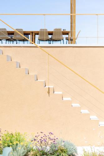 a staircase in a house with chairs and a table at Nine Olives Hvar in Stari Grad