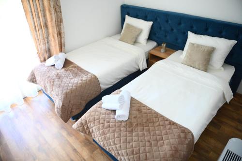 a room with two beds and a table in it at Vila Mir in Banja Vrućica