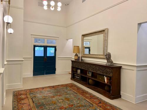 a room with a mirror and a table with a rug at Warner Hotel in Bisbee