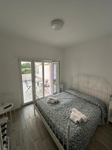 a bedroom with a bed with two towels on it at SEASIDE Bed and Breakfast in Praia a Mare