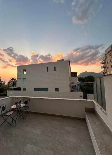 a balcony with a table and chairs on a building at SEASIDE Bed and Breakfast in Praia a Mare