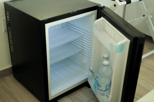 an open refrigerator with two bottles of water in it at SEASIDE Bed and Breakfast in Praia a Mare