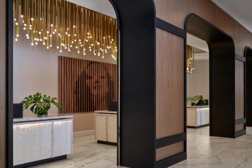 a lobby with a reception desk and a chandelier at InterContinental San Antonio Riverwalk by IHG in San Antonio